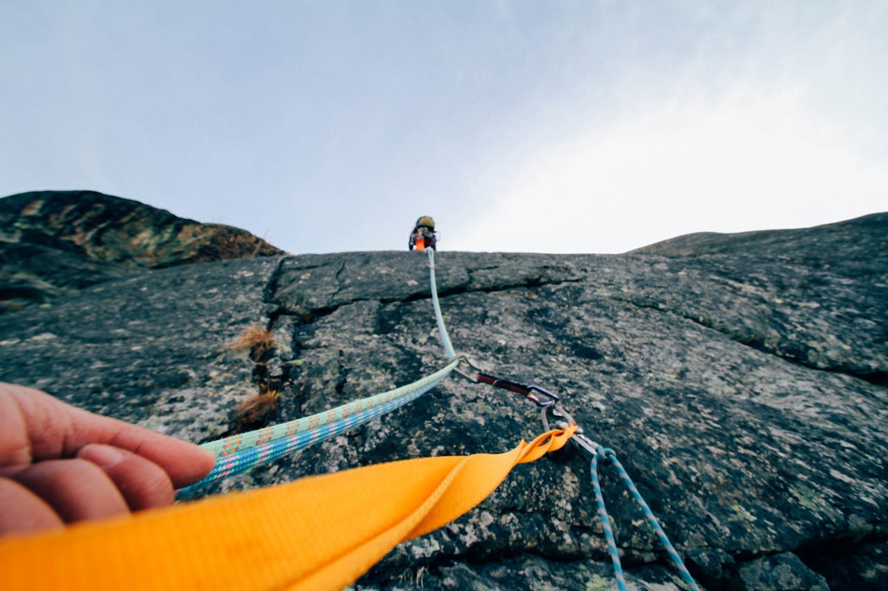 about-img Capture the thrill of rock climbing with this dynamic low-angle shot showcasing determination and teamwork.